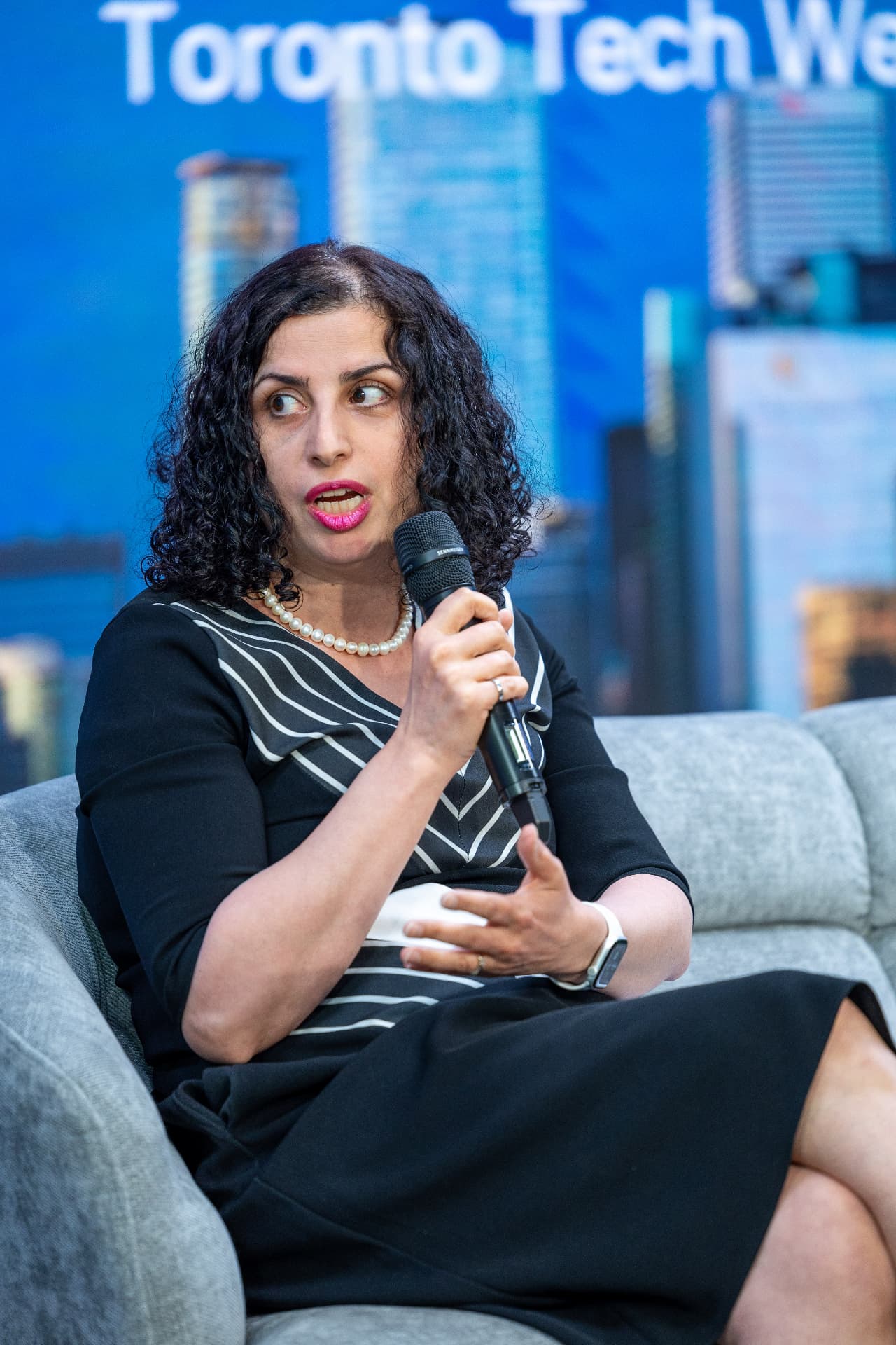 Mojgan Jadidi speaking into a microphone at Toronto Tech Week 2026